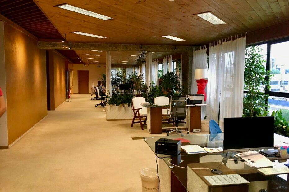 black monitor on table near printer paper on office area of the building with no people