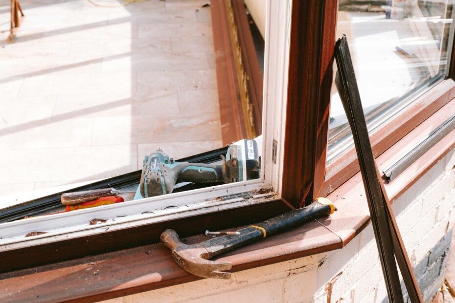 Hammer and drill on window sill during repair